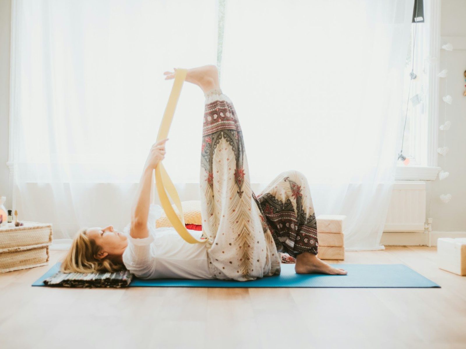 a woman doing a yoga pose on a yoga mat